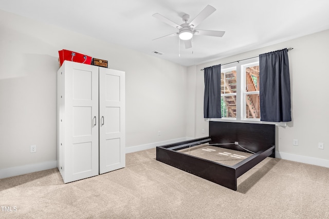 carpeted bedroom featuring visible vents, baseboards, and ceiling fan