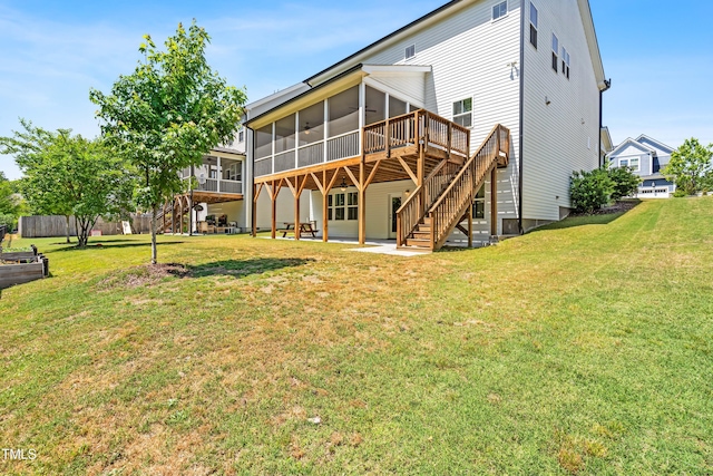 rear view of house featuring a sunroom, a yard, stairway, and a patio