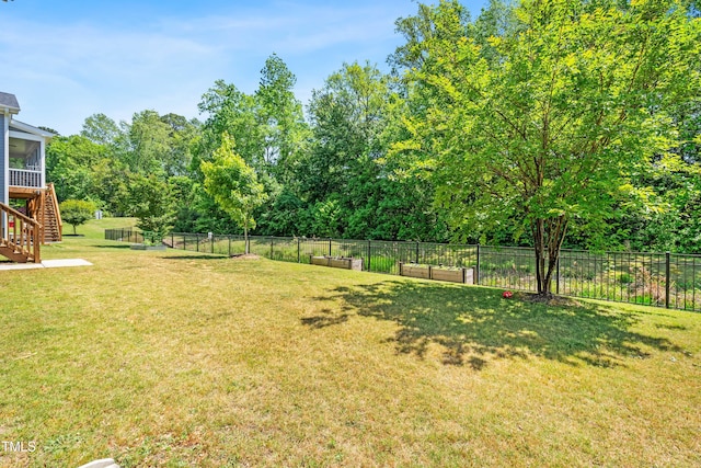 view of yard with fence and stairway