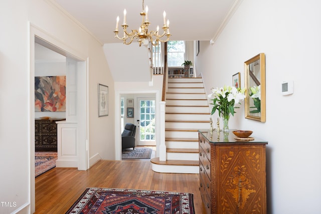 19 Oak Dr, Durham, NC 27707 - foyer entrance with crown molding, a chandelier, wood finished floors, and a wealth of natural light