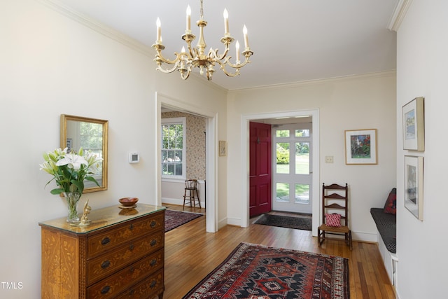 19 Oak Dr, Durham, NC 27707 - entryway with crown molding, a notable chandelier, a healthy amount of sunlight, and wood-type flooring