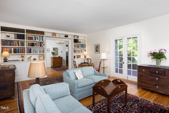 19 Oak Dr, Durham, NC 27707 - living area with an inviting chandelier, built in features, ornamental molding, and light wood-type flooring