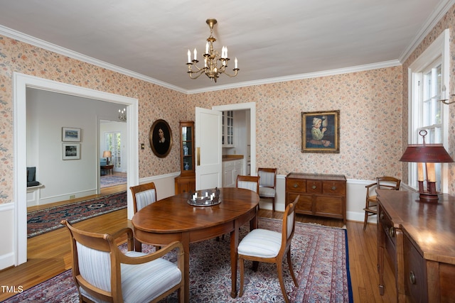 19 Oak Dr, Durham, NC 27707 - dining room with wood finished floors, a wainscoted wall, a notable chandelier, ornamental molding, and wallpapered walls