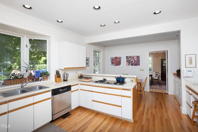 19 Oak Dr, Durham, NC 27707 - kitchen featuring dishwasher, a sink, light countertops, a peninsula, and white gas stovetop