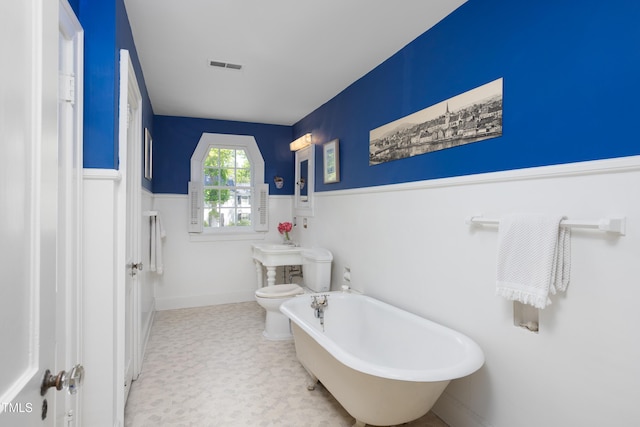 19 Oak Dr, Durham, NC 27707 - full bath with a soaking tub, wainscoting, toilet, and visible vents