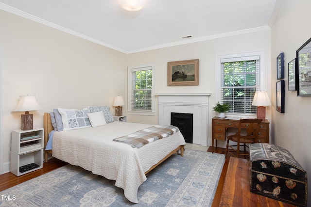 19 Oak Dr, Durham, NC 27707 - bedroom featuring crown molding, a fireplace with flush hearth, wood finished floors, and visible vents