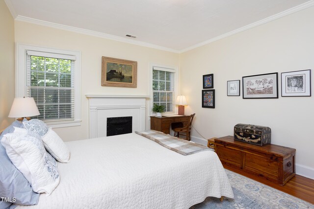 19 Oak Dr, Durham, NC 27707 - bedroom featuring a fireplace, baseboards, wood finished floors, visible vents, and ornamental molding