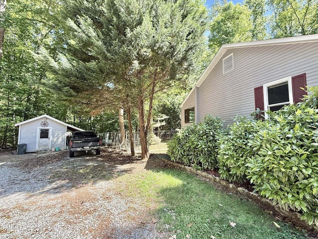 view of yard with an outdoor structure and gravel driveway