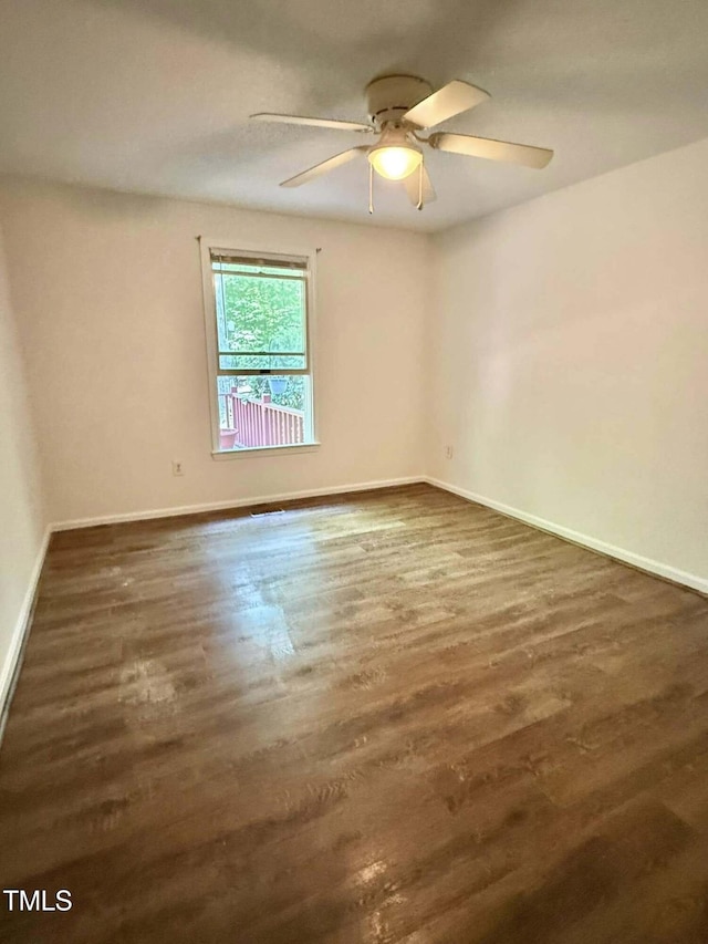 unfurnished room with ceiling fan, baseboards, and wood finished floors