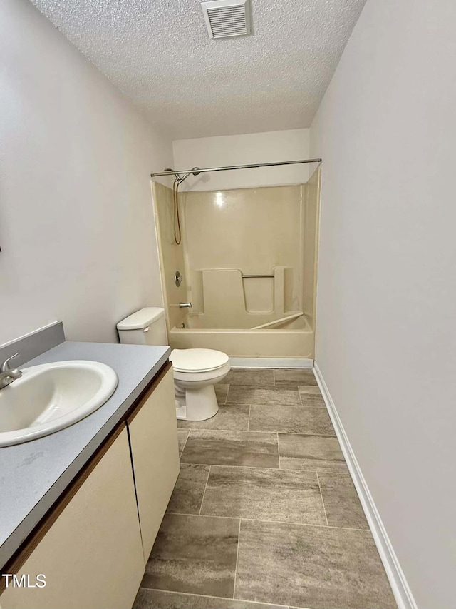 bathroom with washtub / shower combination, vanity, toilet, a textured ceiling, and visible vents