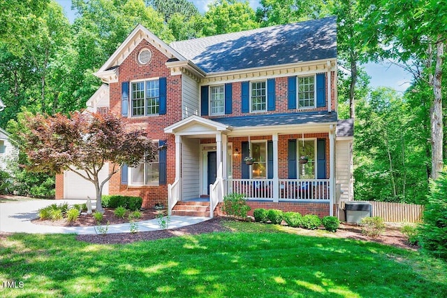 105 Wittenham Dr, Cary, NC 27519 - view of front of home featuring covered porch, brick siding, a shingled roof, and driveway