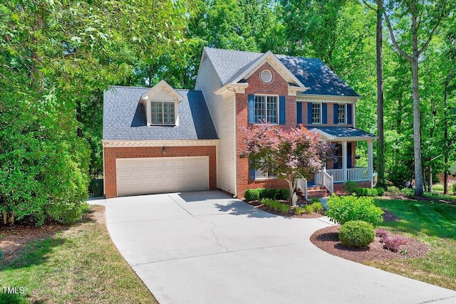 105 Wittenham Dr, Cary, NC 27519 - view of front facade with a porch, concrete driveway, an attached garage, and brick siding