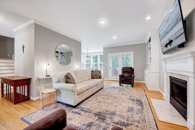 105 Wittenham Dr, Cary, NC 27519 - living area with crown molding, light wood finished floors, stairway, baseboards, and recessed lighting