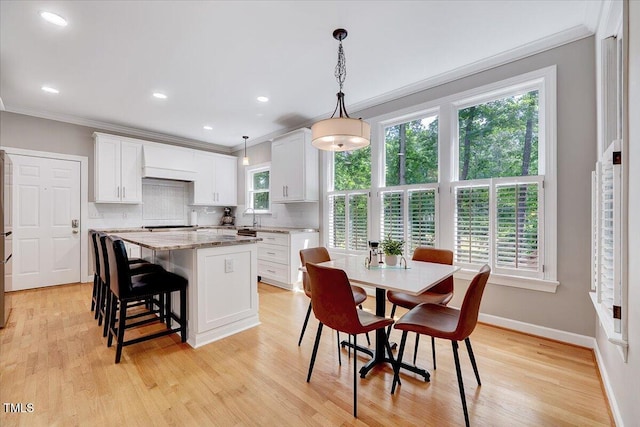 105 Wittenham Dr, Cary, NC 27519 - dining space featuring crown molding, baseboards, light wood-style floors, and recessed lighting