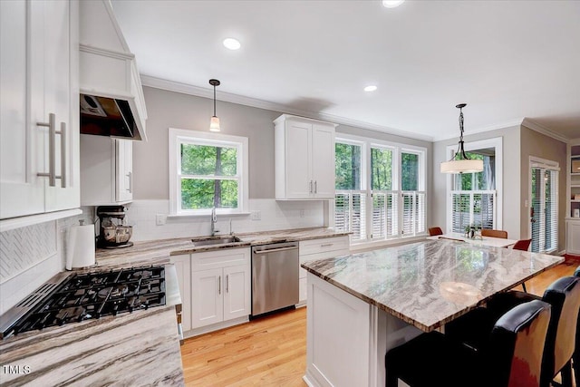 105 Wittenham Dr, Cary, NC 27519 - kitchen featuring stainless steel dishwasher, ornamental molding, a sink, white cabinets, and a breakfast bar