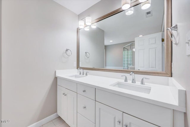 105 Wittenham Dr, Cary, NC 27519 - full bathroom featuring a shower stall, double vanity, baseboards, and tile patterned flooring