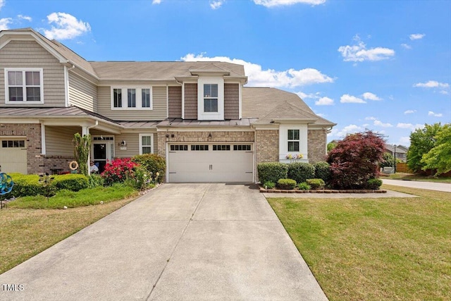 view of front of house with an attached garage, a front yard, concrete driveway, a standing seam roof, and metal roof