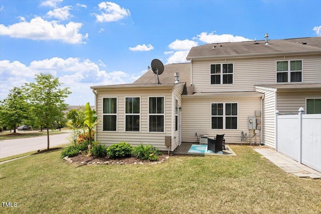 back of house featuring fence, a patio, and a yard
