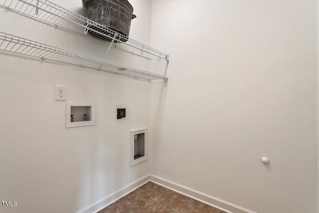 clothes washing area with laundry area, baseboards, dark tile patterned flooring, washer hookup, and hookup for an electric dryer