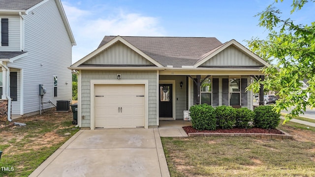 craftsman-style house with a porch, an attached garage, board and batten siding, and cooling unit