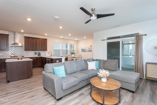 living room featuring light wood-style floors, a ceiling fan, recessed lighting, and visible vents
