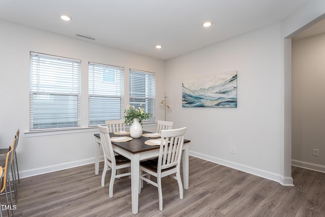 dining room featuring recessed lighting, baseboards, visible vents, and wood finished floors