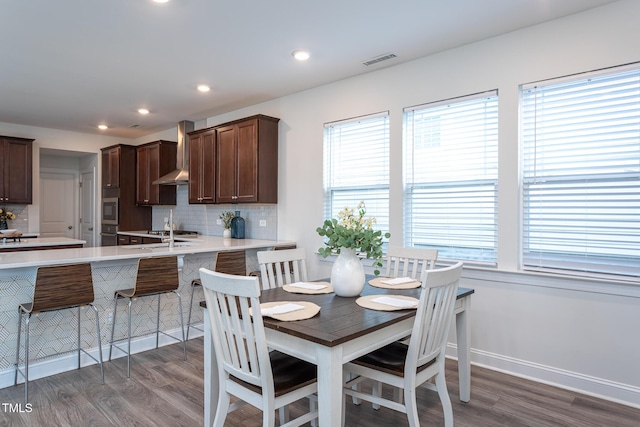 dining area featuring visible vents, recessed lighting, plenty of natural light, and wood finished floors