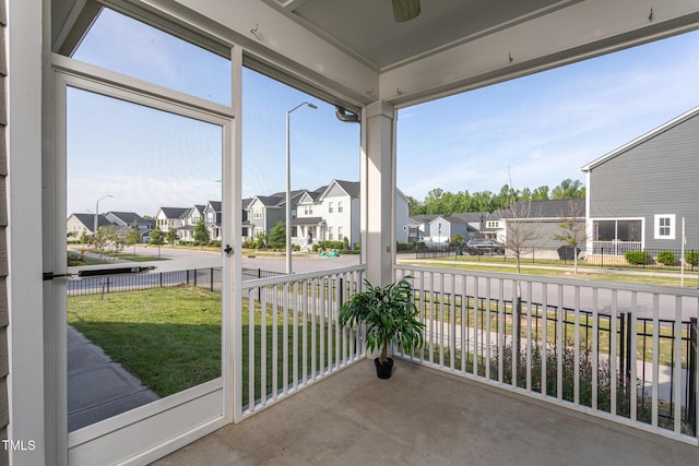 unfurnished sunroom with plenty of natural light and a residential view