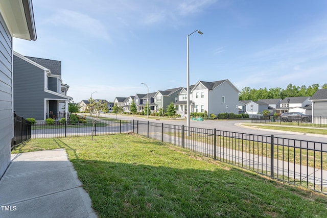view of yard featuring fence and a residential view