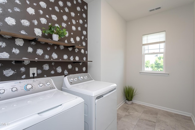 washroom featuring laundry area, baseboards, wallpapered walls, visible vents, and washing machine and dryer