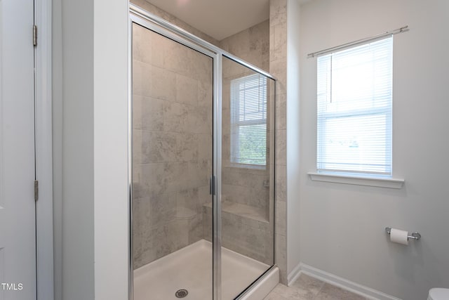 full bathroom featuring baseboards, a shower stall, and tile patterned floors