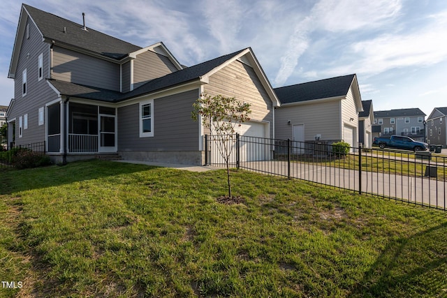 view of home's exterior with fence, concrete driveway, an attached garage, and a sunroom