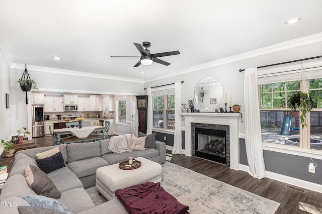 180 Long Grass Dr, Smithfield, NC 27577 - living room featuring crown molding, visible vents, a fireplace, ceiling fan, and dark wood finished floors