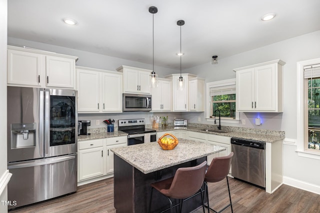 180 Long Grass Dr, Smithfield, NC 27577 - kitchen featuring a kitchen island, white cabinets, a sink, dark wood finished floors, and stainless steel appliances