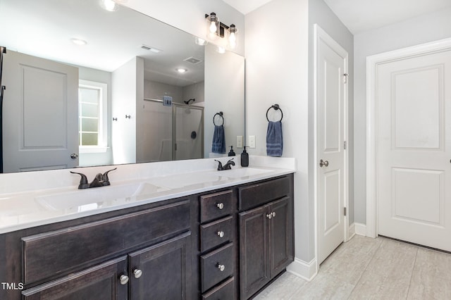 180 Long Grass Dr, Smithfield, NC 27577 - bathroom featuring double vanity, visible vents, a shower stall, and a sink