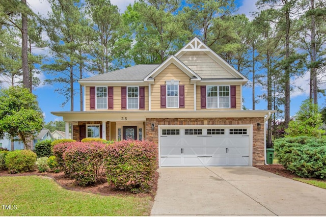 view of front of home with covered porch, an attached garage, and driveway