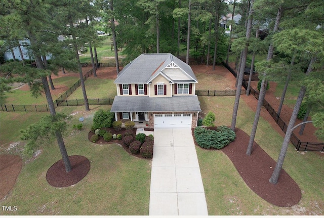 traditional-style home featuring driveway, a garage, an outdoor structure, a fenced backyard, and a front lawn