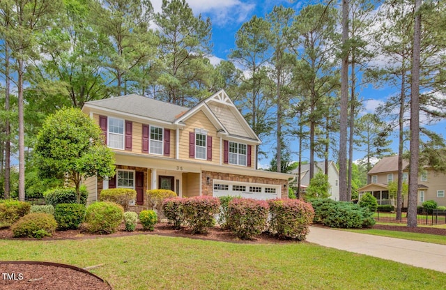 view of front of home featuring an attached garage, concrete driveway, and a front yard