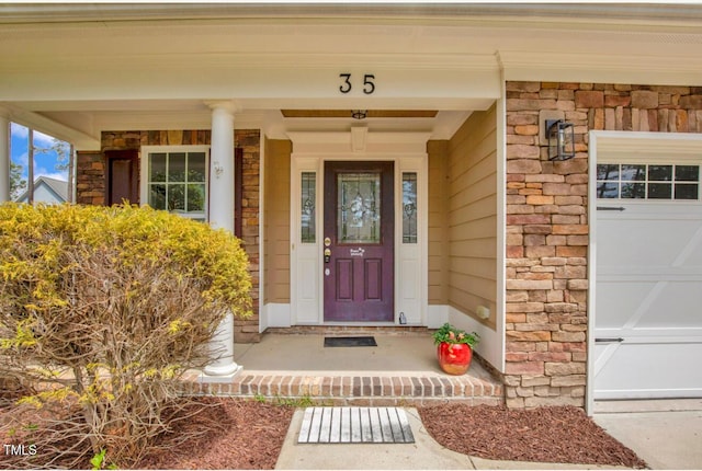 doorway to property with covered porch and stone siding