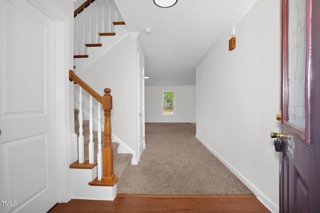 interior space featuring stairs and baseboards