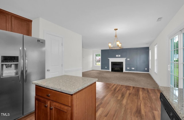 kitchen with dark wood-style flooring, an inviting chandelier, stainless steel fridge, hanging light fixtures, and dishwasher
