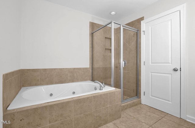 bathroom featuring a whirlpool tub, tile patterned floors, and a shower stall
