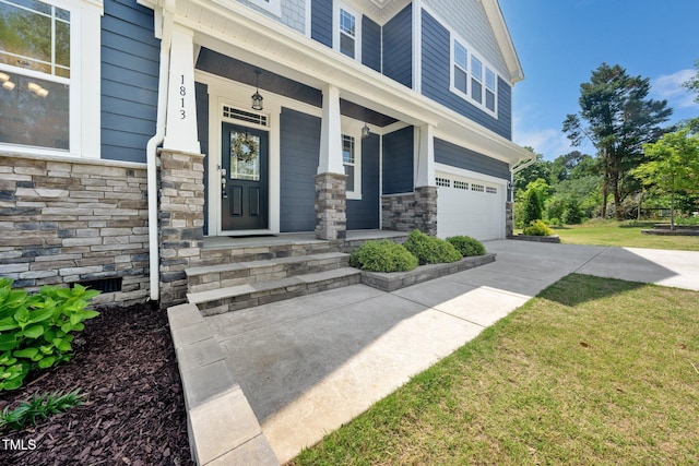 1813 Lost Creek Ct, Apex, NC 27539 - view of exterior entry featuring stone siding, an attached garage, covered porch, driveway, and a yard