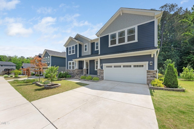 craftsman inspired home with a garage, a front lawn, driveway, and stone siding