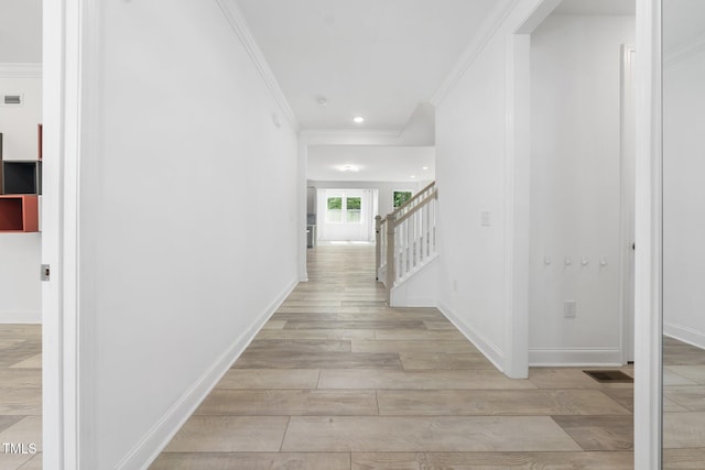 hallway with baseboards, ornamental molding, stairs, and recessed lighting