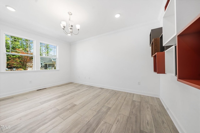 unfurnished room featuring a chandelier, baseboards, light wood-type flooring, visible vents, and ornamental molding