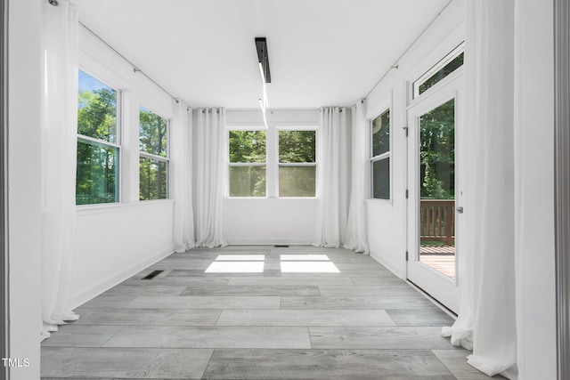 unfurnished sunroom featuring french doors, wood finished floors, and visible vents