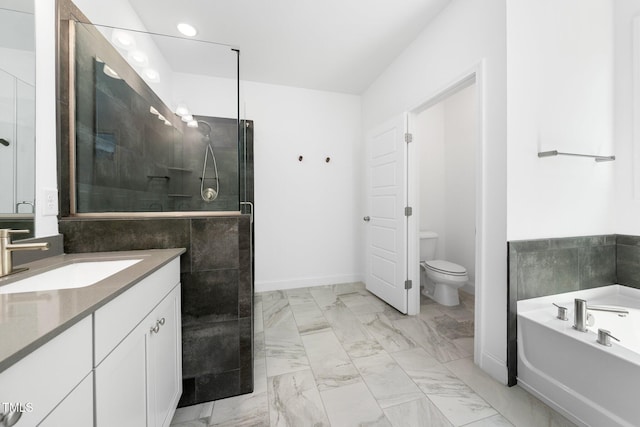 bathroom featuring a garden tub, a stall shower, vanity, toilet, and marble finish floor