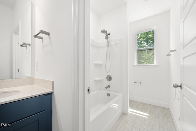 bathroom featuring vanity, baseboards, and shower / washtub combination