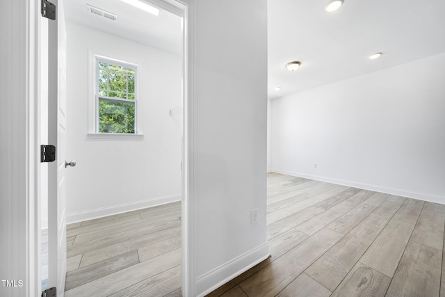 interior space with visible vents, baseboards, and wood finished floors